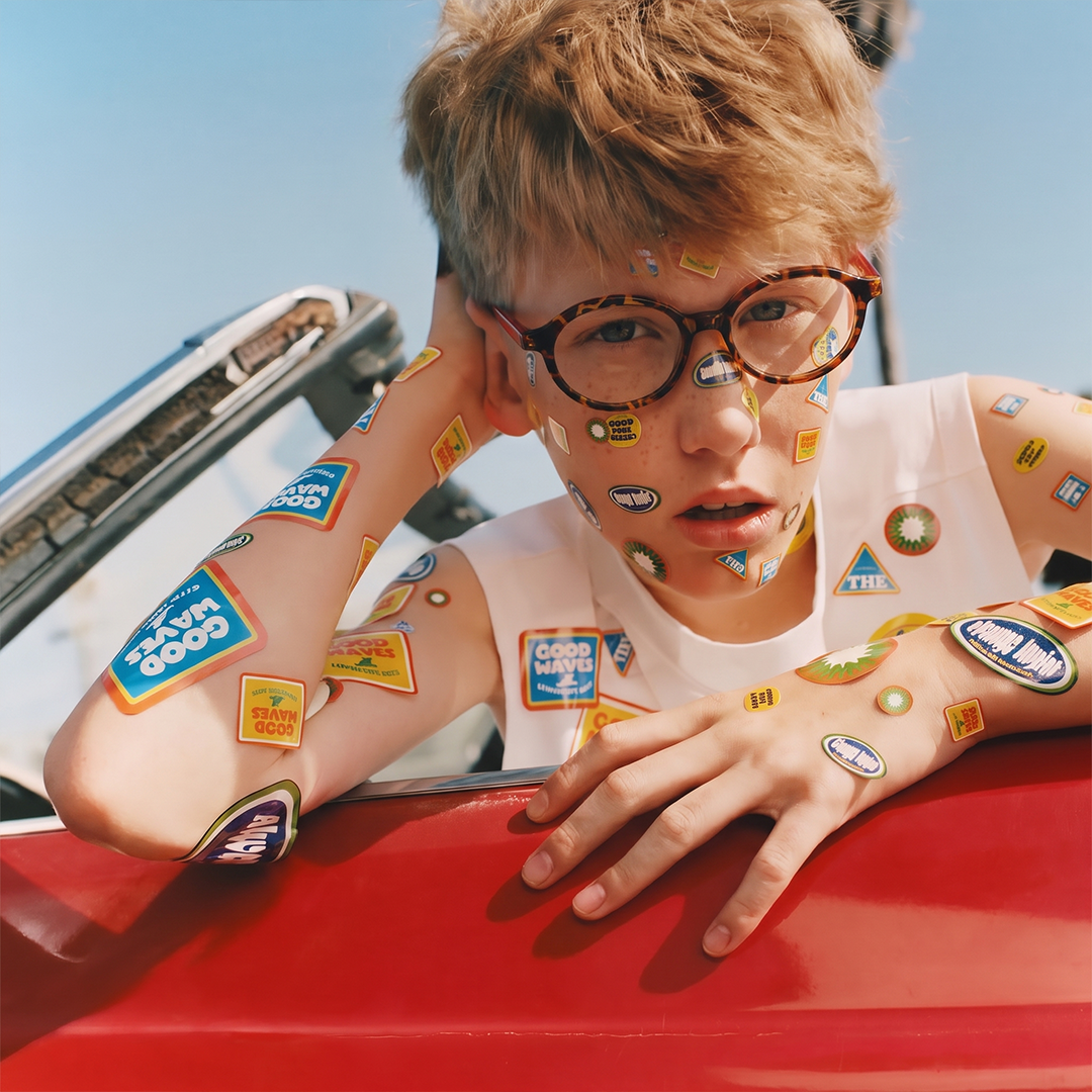 Decorative eyeglasses with dark frame and colorful sticker-style accents
