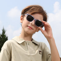 2-in-1 eyewear sunglasses with transparent blue frame and dark lenses, side view