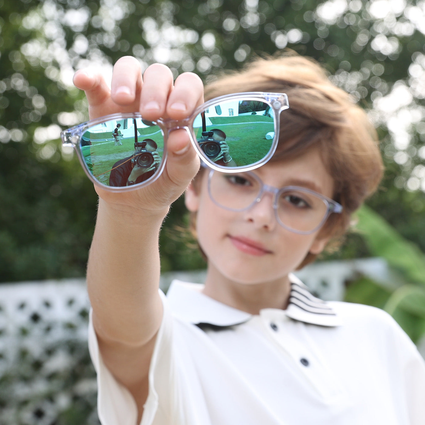 2-in-1 eyewear with transparent blue frame and dark-tinted lenses, close-up