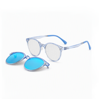 Transparent blue eyeglasses with blue-tinted oval lenses, plus an extra lens cover