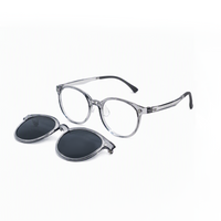 Clear frame eyeglasses with dark flip-down clip lenses