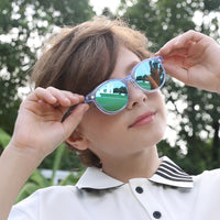 Kids 2-in-1 sunglasses with transparent blue frames and green mirrored lenses