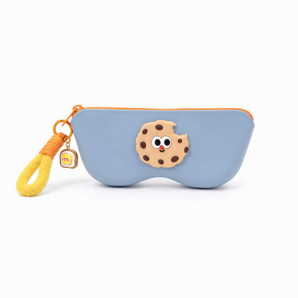 Blue pencil case with orange zipper and cookie-face patch; yellow tassel keychain charm