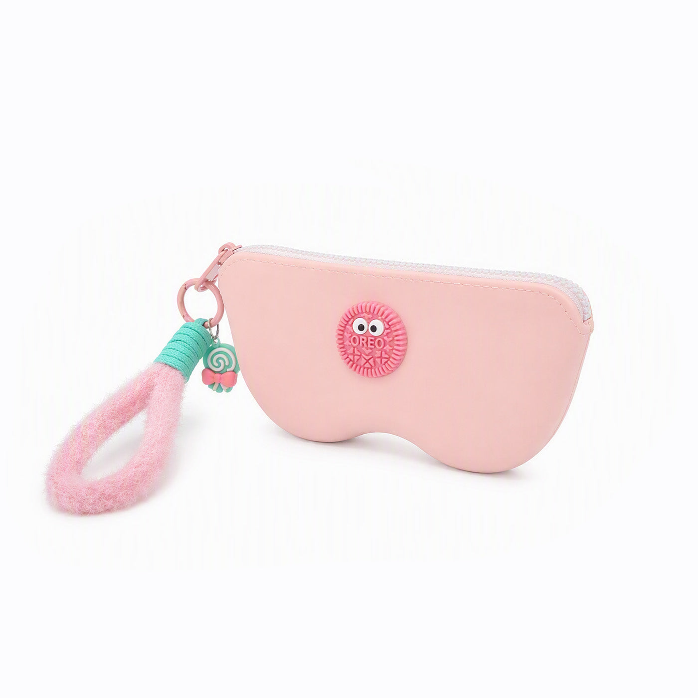 Pink pencil case with light pink zipper and owl-style patch; pink-and-green tassel charm
