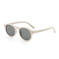 Sunglasses with light beige frames and dark tinted round lenses, side view