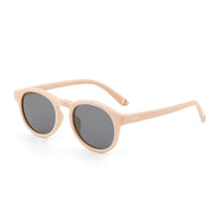 Beige kids sunglasses angled side view with dark lenses and thin temples