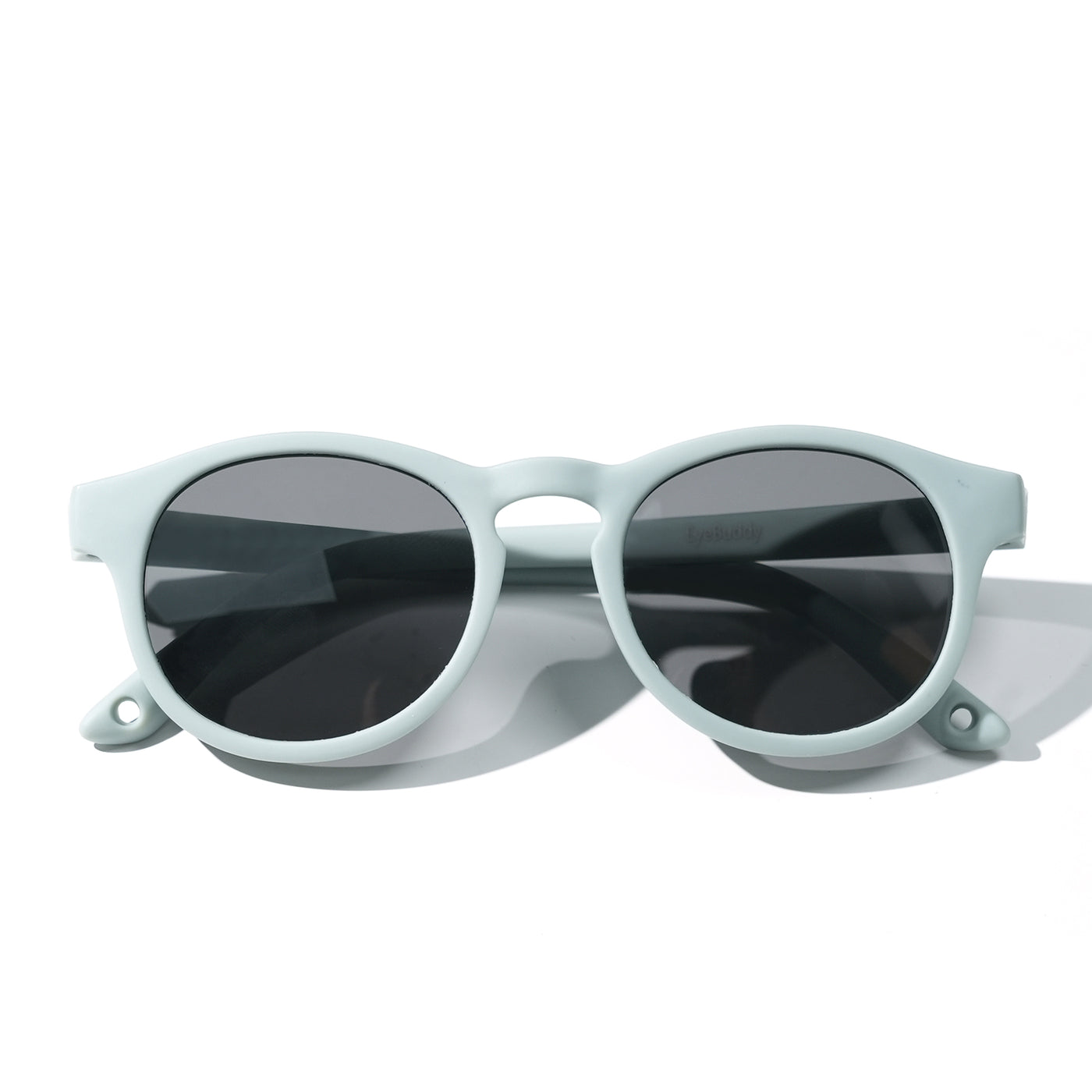 Sunglasses with light mint frames and dark tinted oval lenses