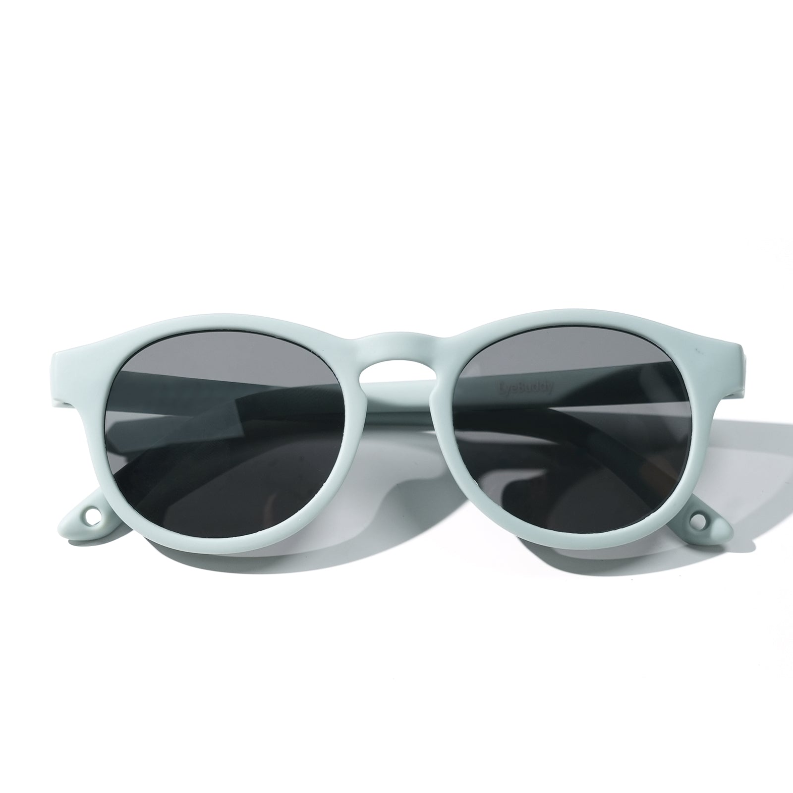 Sunglasses with light mint frames and dark tinted oval lenses