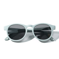 Sunglasses with light mint frames and dark tinted oval lenses