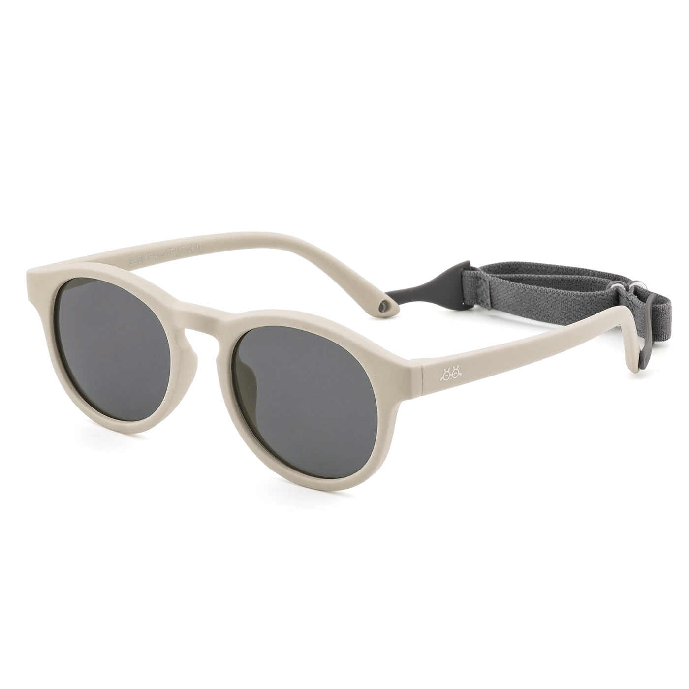 Sunglasses with light beige frames, dark lenses, and adjustable strap