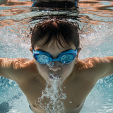 realistic headshot of a boy swimming butterfly style wearing swimming goggles